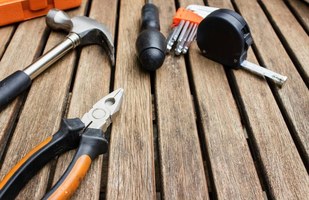 Hammer, pliers and tape measure on a workbench