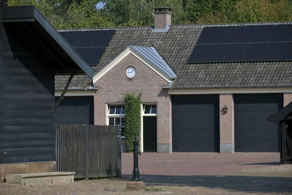 Brick home with dark garage doors