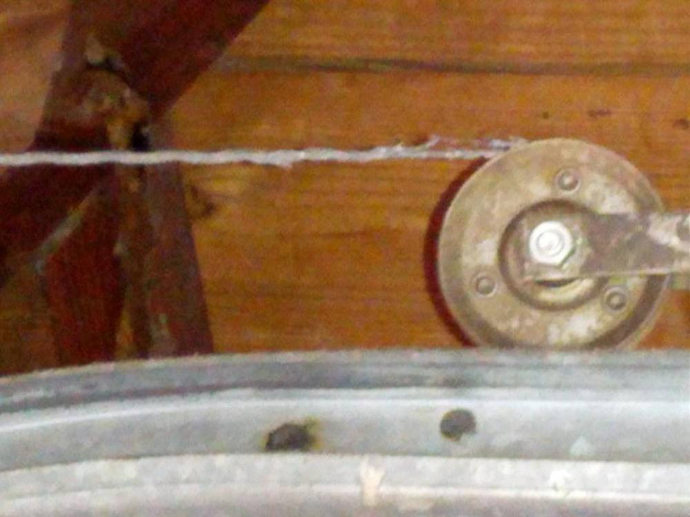 Garage door lift cable and pulley above the door track