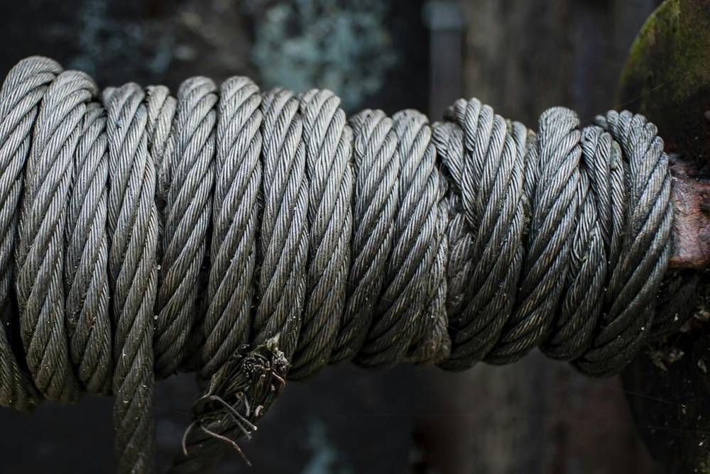 Steel cable wrapped around a post