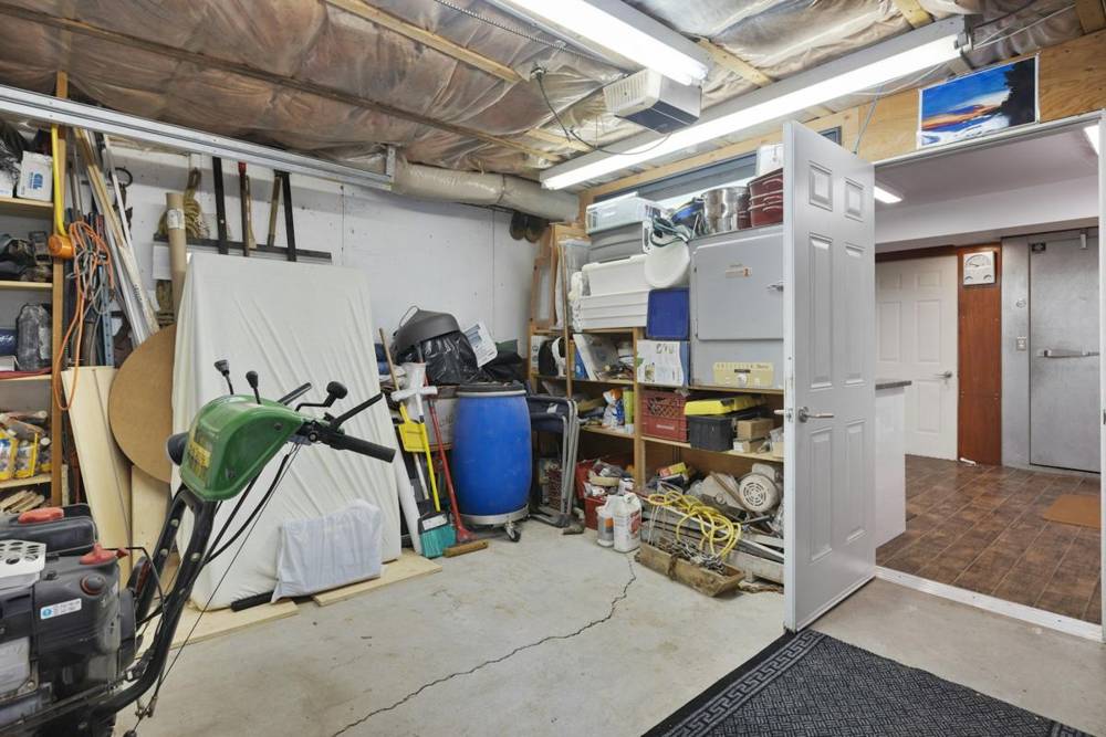 Inside a home garage with shelves and storage