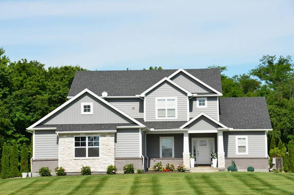 Gray two-story house with a front lawn