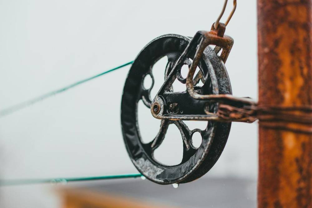 Cable running over a metal pulley wheel