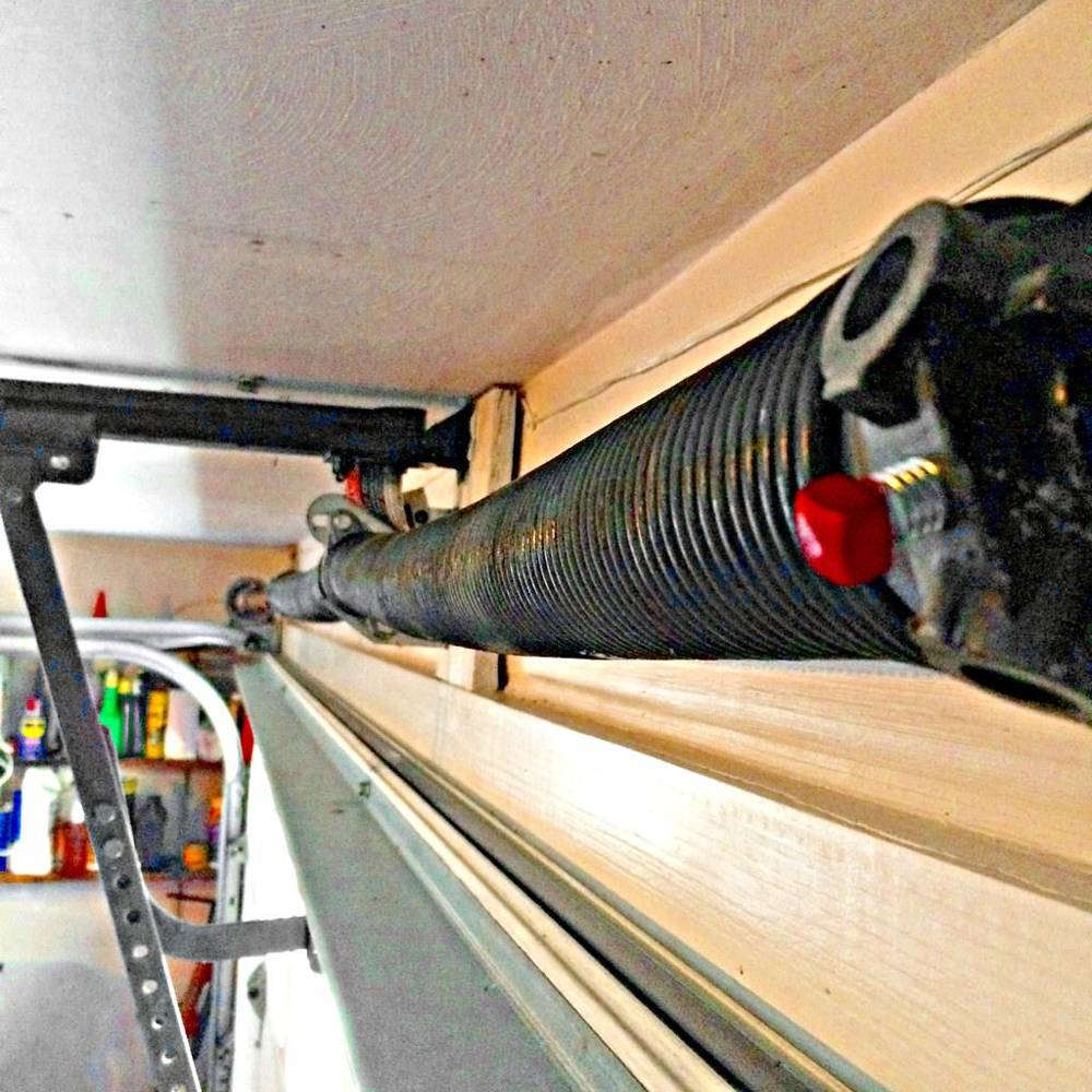Torsion spring on the metal bar above a garage door