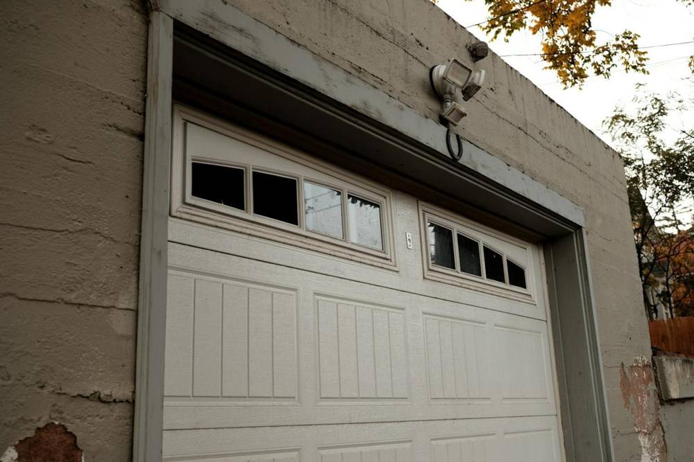 White raised-panel garage door with a row of windows