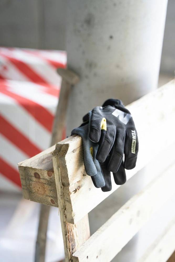 Work gloves hanging on a wooden ladder